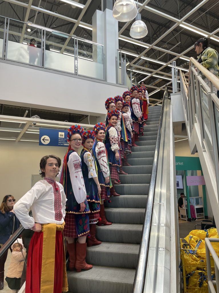 Rozmai dancers standing on staircase at IKEA Winnipeg